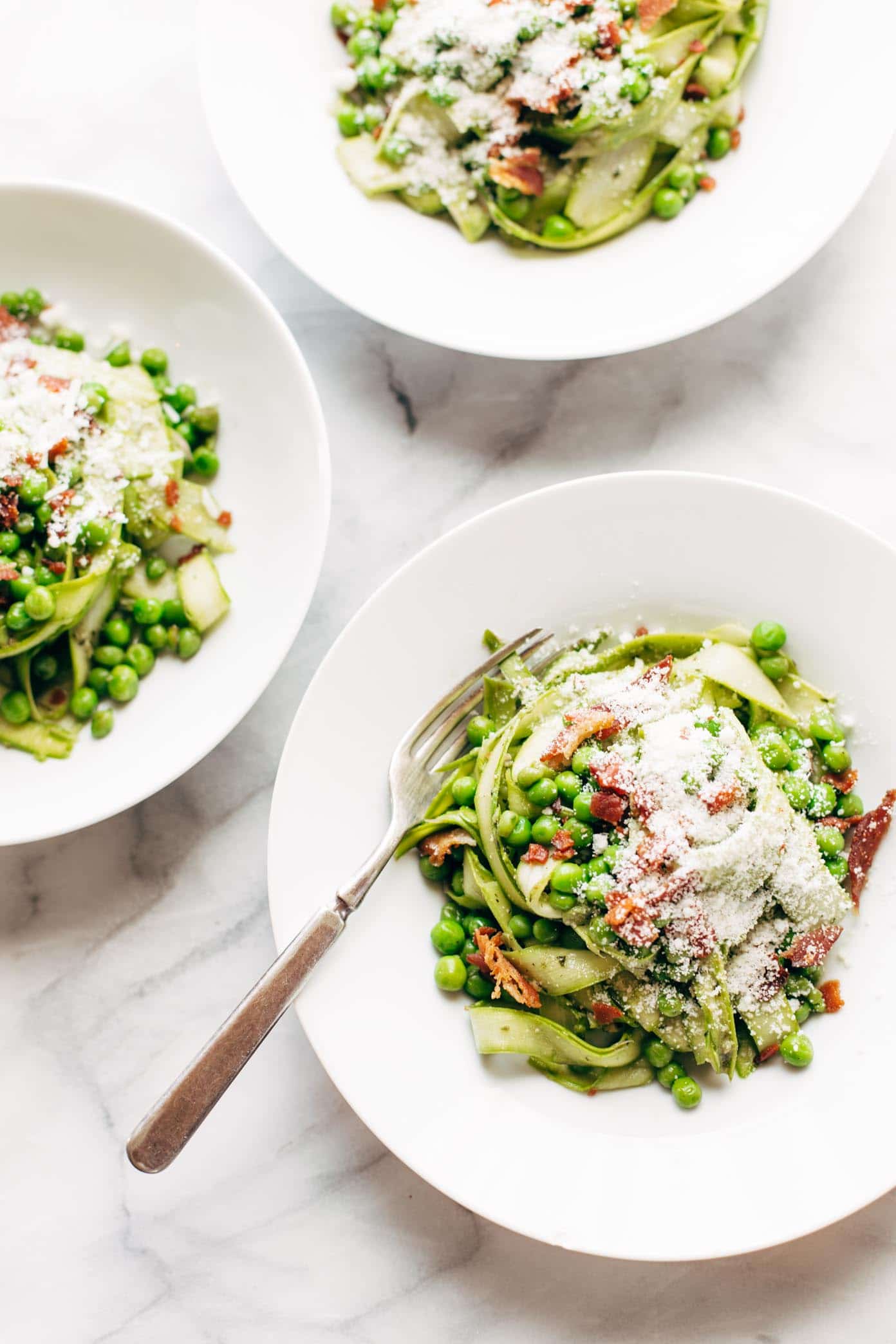 Asparagus noodles with pesto in white bowl 