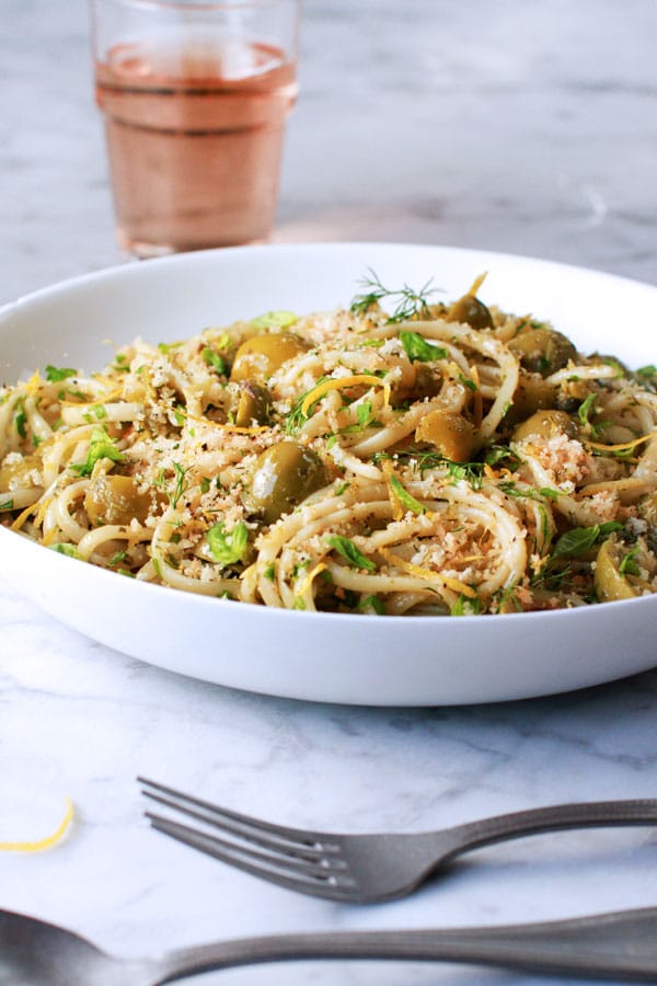 Linguine in a bowl with castelvetrano olives and breadcrumbs