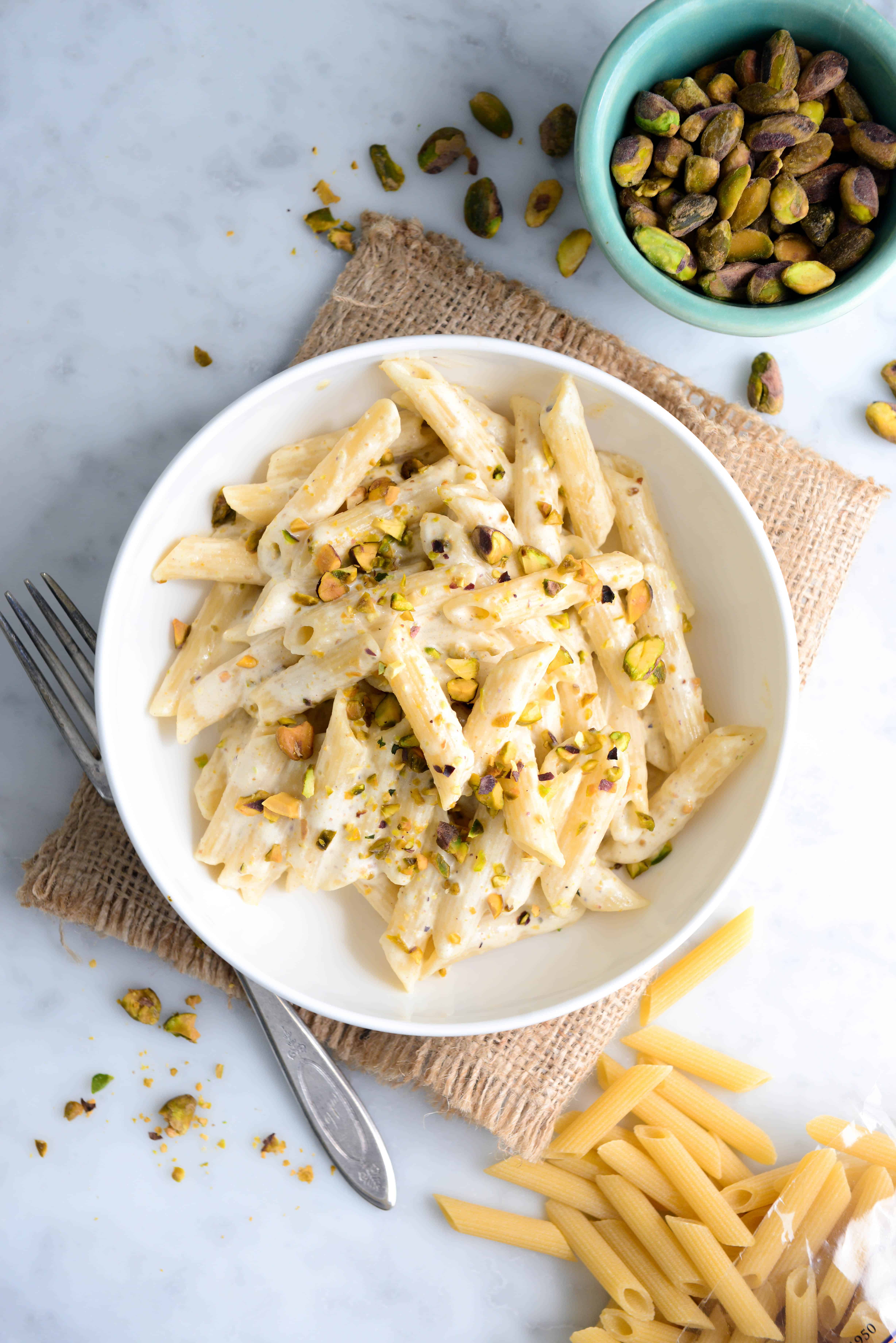 Pasta in pistachio sauce with pistachios chopped on top of pasta