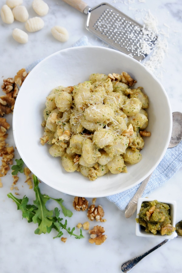 A bowl of potato gnocchi topped with shake cheese. 