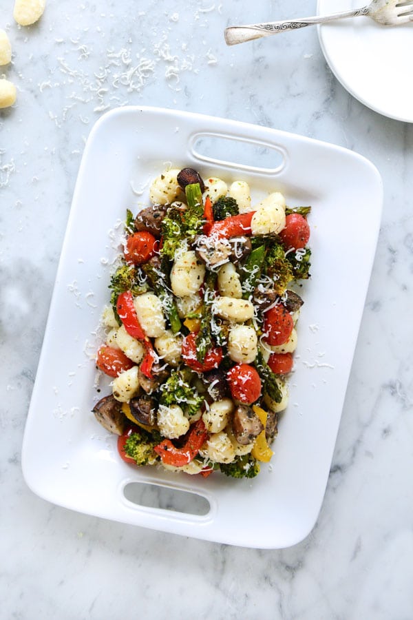 Gnocchi with garlic and vegetables on a white plate