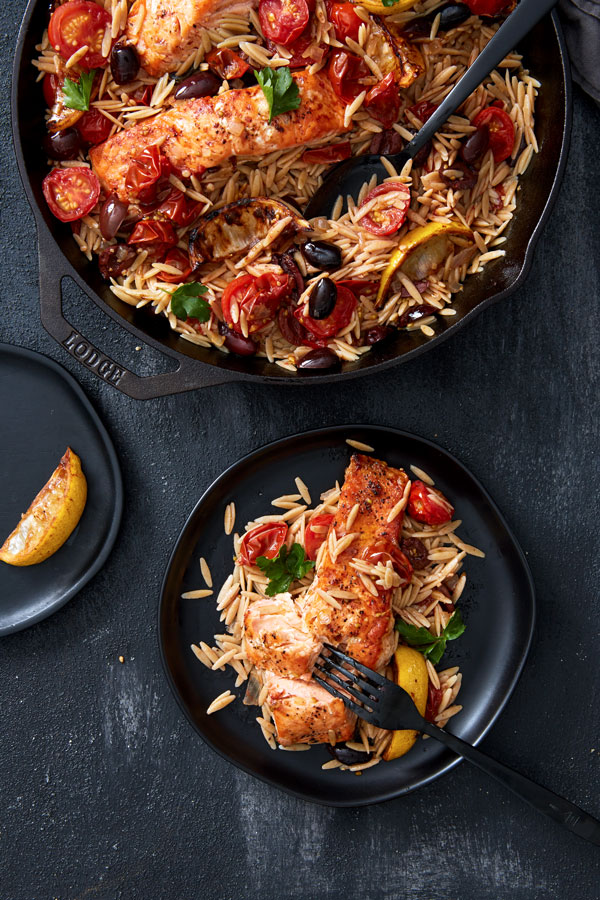 Salmon Tuscano with Orzo and tomatoes served on a dish