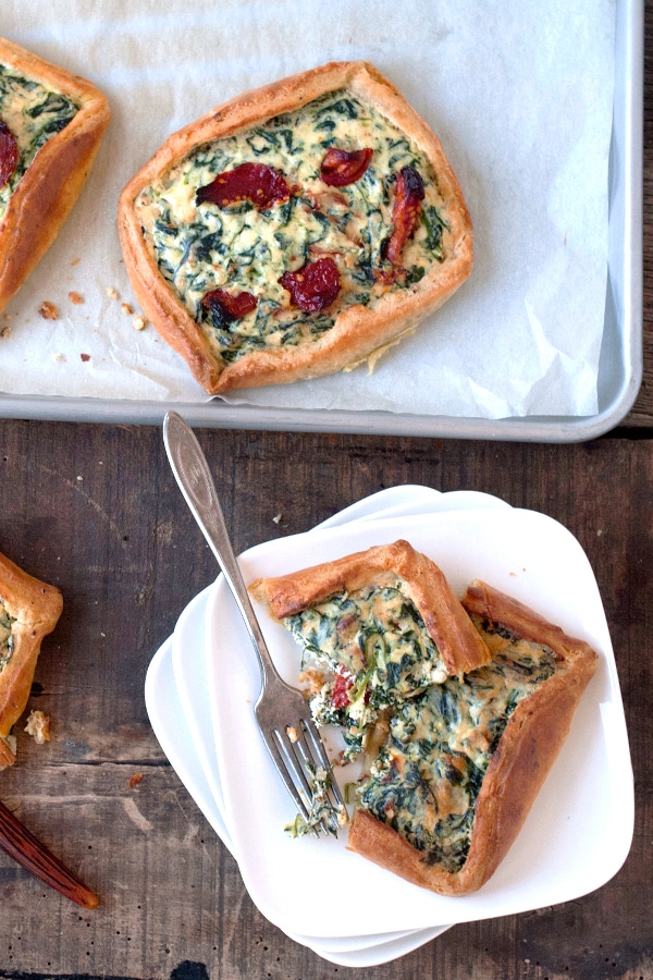 Spinach and sun dried tomato crostata on parchment paper 