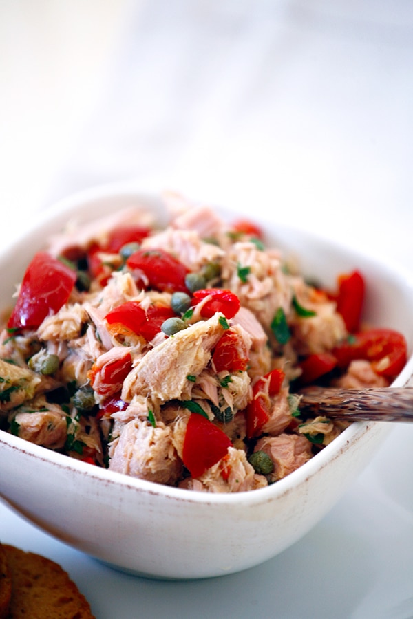 Spicy pepperazzi peppers mixed into a  tuna salad served in a square bowl. 