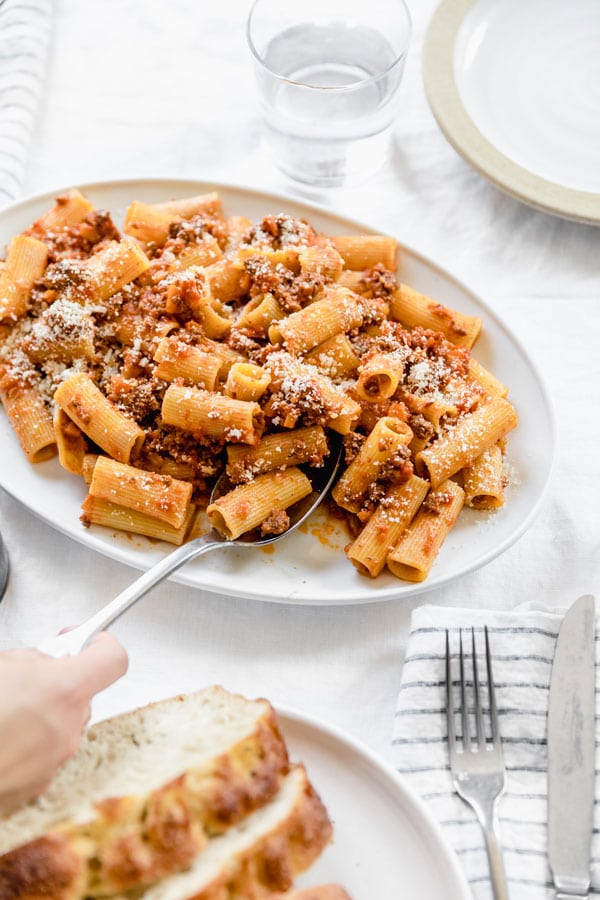 The Best Bolognese Sauce pictured with rigatoni and parmesean cheese