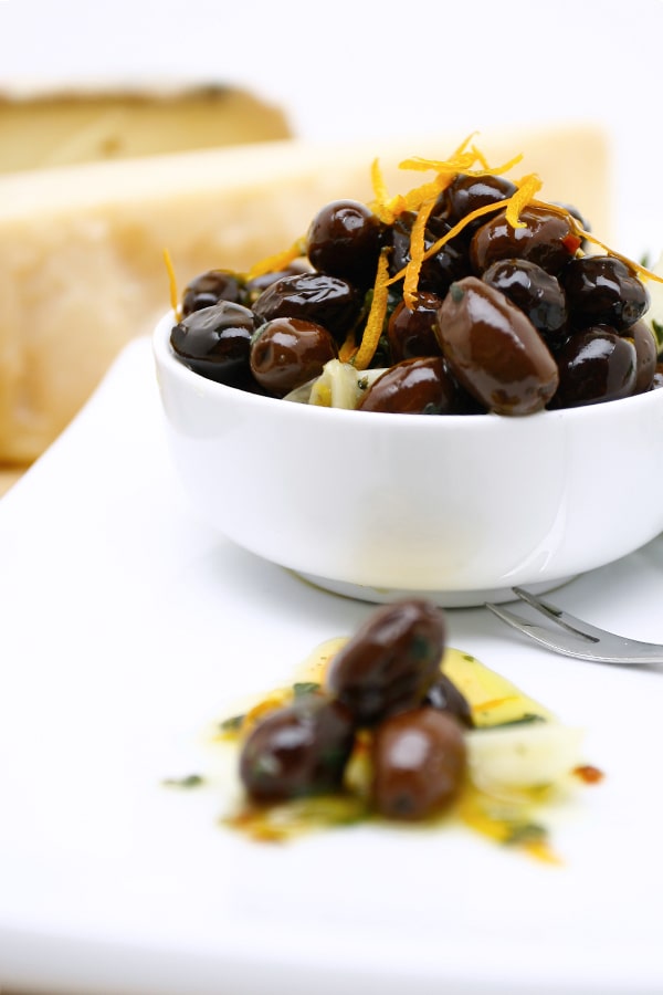 Warm Pitted Calamata Olives in white bowl 