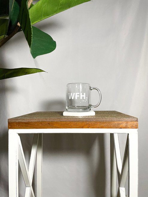 Clear mug with WFH club in white on table