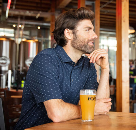 Man wearing Cutter & Buck printed polo at a pub