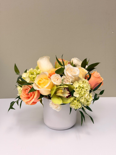 Soft roses and delicate blooms gathered in a refined, garden-style design. Presented in a clean ceramic vessel — understated, elegant, and perfect for any special occasion.
