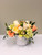 Soft roses and delicate blooms gathered in a refined, garden-style design. Presented in a clean ceramic vessel — understated, elegant, and perfect for any special occasion.
