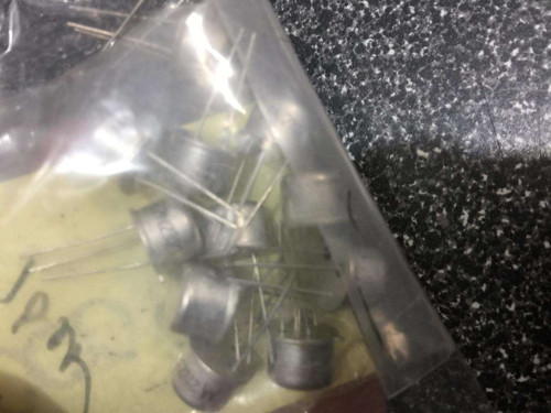 Plastic bag containing approximately 15 unused through-hole SCRs with leads intact; handwritten "10x" label visible on bag exterior.