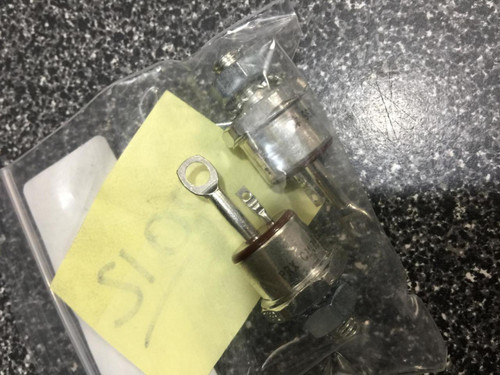 Metal-bodied SCR with stud-mount base and top terminal. Yellow adhesive label with handwritten notation visible on face.