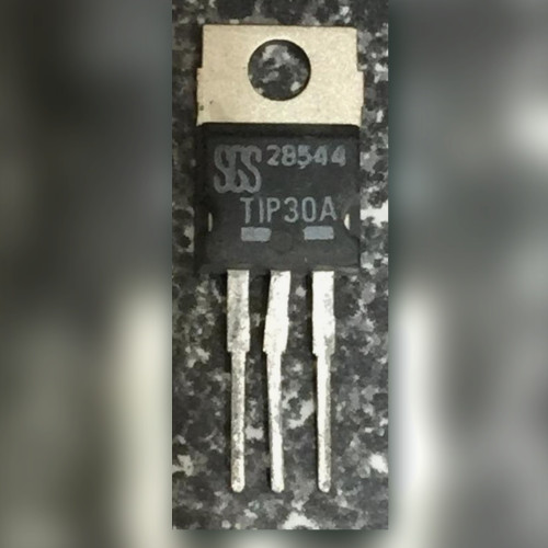 TO-220 transistor marked with SGS logo and TIP30A, three leads, on a speckled black and white surface