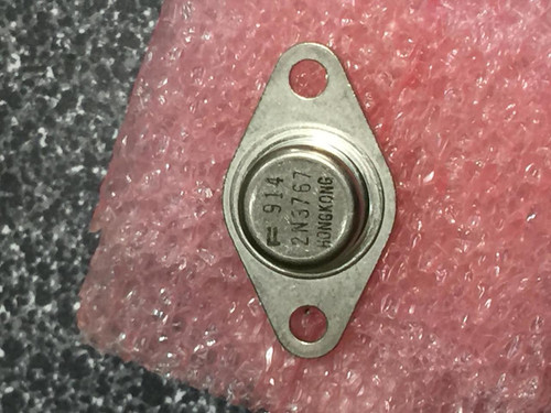 Fairchild 2N3767 power transistor in a metal case showing the model number and mounting holes.