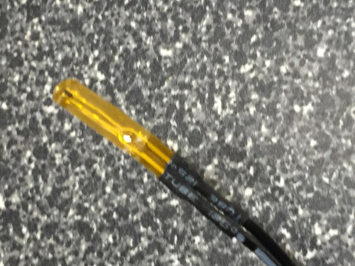 Close-up of amber film thermistor tip with white printed lettering on black lead sleeving.