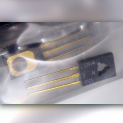Two transistors in clear plastic, one face marked 2N4921, the other showing a gold-coloured tab