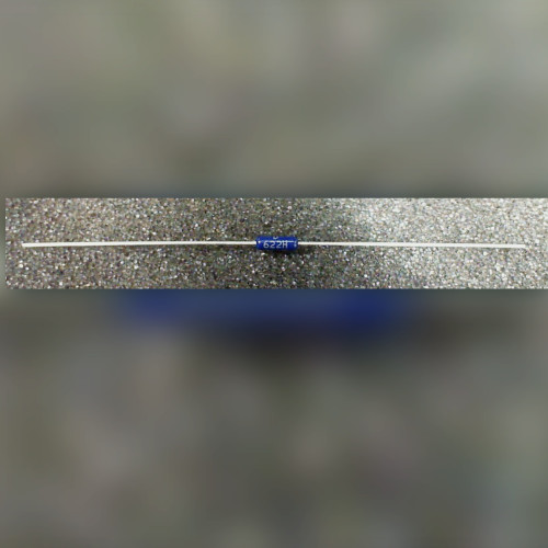 Dark blue axial resistor with long straight leads on a gray speckled surface