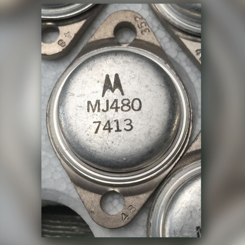 Close-up of Motorola MJ480 TO-3 transistor can stamped with M logo and date code 7413