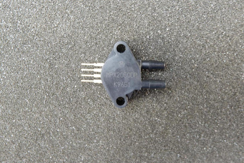 Motorola MPX2050DP differential pressure sensor module showing dual barbed ports and through-hole SIP pins.