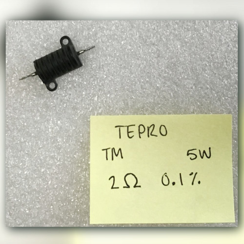 Small black finned resistor on light crinkled surface beside yellow note TEPRO TM 5W 2 ohm 0.1%