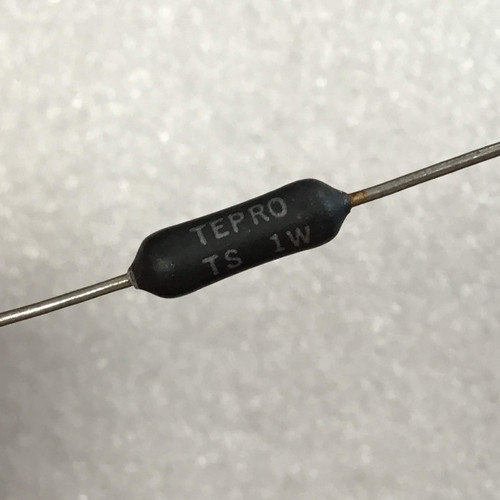 Close view of black tapered resistor body printed TEPRO and TS 1W, silver leads
