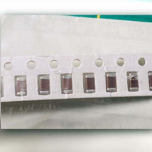 Close view of three brown ceramic chip capacitors with silver end terminations