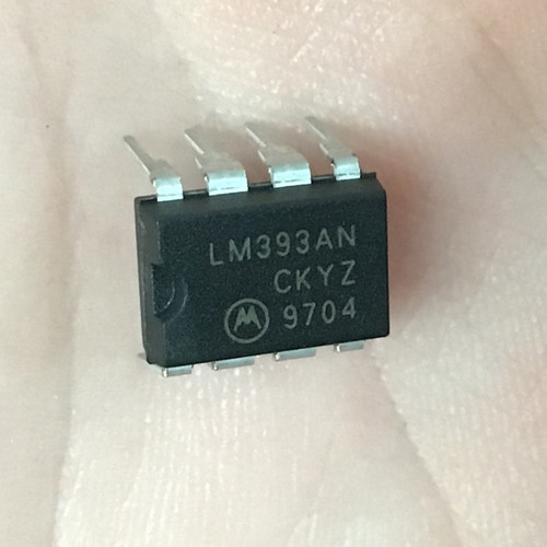 DIP-8 black plastic package marked LM393AN / CKYZ / 9704 with Motorola logo. Leads appear straight and clean.