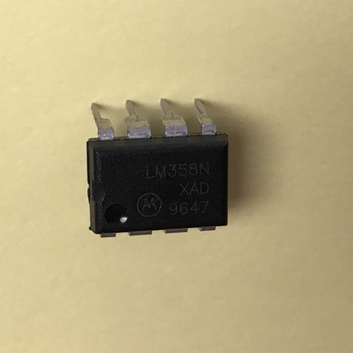 DIP-8 black plastic package marked "LM358N / XAD / 9647" with Motorola logo. Eight leads present, pins unbent.
