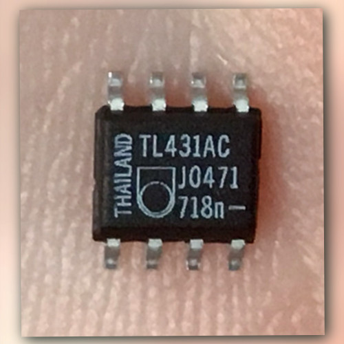 Black SO-8 chip on a light crinkled backdrop, printed TL431AC, J0471, 718n and THAILAND