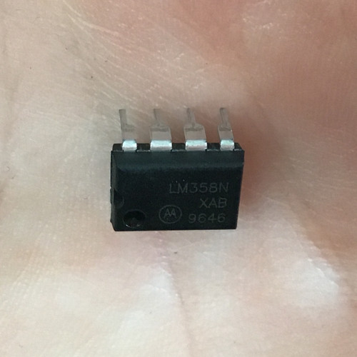 Black DIP-8 plastic package marked "LM358N / XAB / 9646" with Motorola logo. Eight leads present, no visible damage.