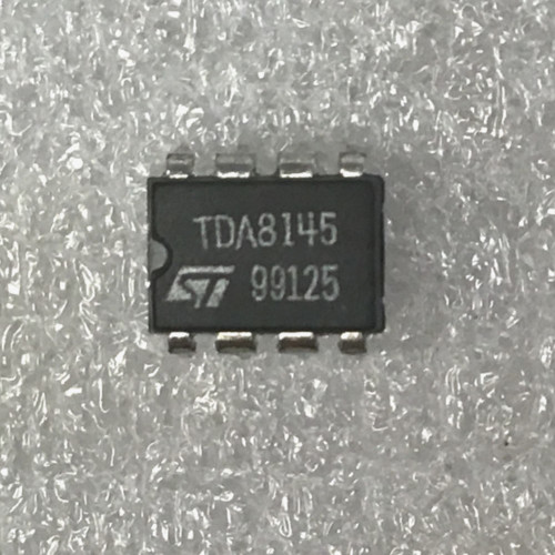 Black 8-pin DIP held between fingers, marked TDA8145 with ST logo and date code 99125