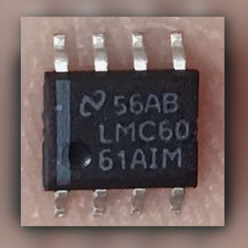 National Semiconductor LMC6061AIM SOIC-8 op amp held in a palm, top markings visible