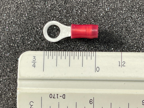 Red-insulated ring terminal, approximately 3/4 inch length confirmed by ruler. Silver barrel visible, closed-barrel style.