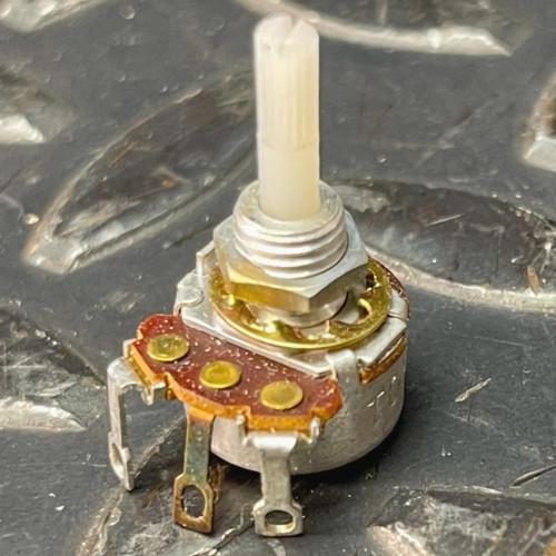 Mallory MLCN55L 500K ohm potentiometer held in palm, plastic shaft and solder lugs visible