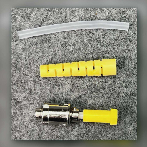3M 8100-YS ST connector unpacked for photography beside yellow boot and clear sleeve