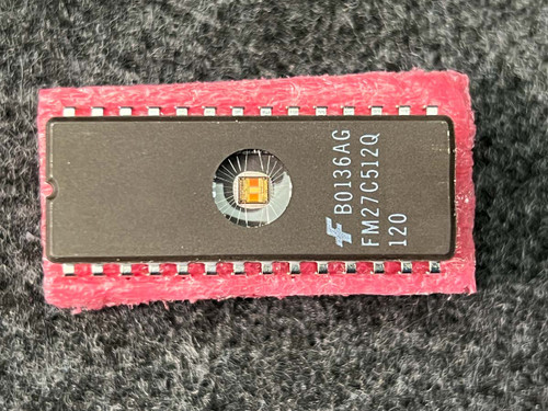Fairchild B0136AG FM27C512Q 120, die visible through window, pins appear straight and clean.