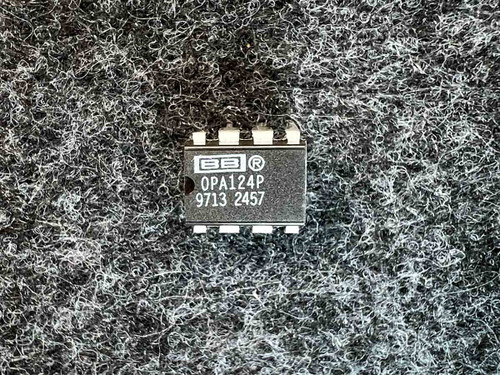DIP-8 package with BB logo, marked OPA124P, date code 9713, lot 2457. Pins unsoldered, body clean, no damage.