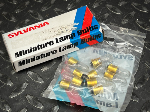 Sylvania 1819 miniature lamp box beside poly bag holding ten brass-based bulbs