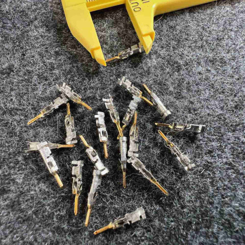 Molex 43031-0009 Micro-Fit 3.0 male crimp terminals loose on gray mat with caliper