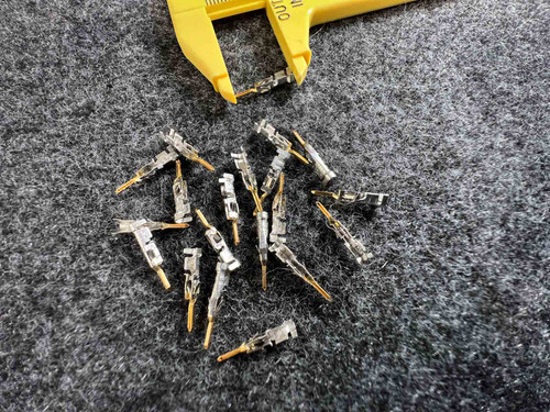 Molex 43031-0009 Micro-Fit 3.0 male crimp terminals loose on gray mat with caliper