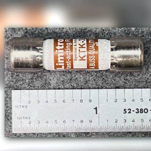 Limitron KTK-3 midget fuse lying beside an inch ruler, label facing camera