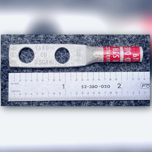 Burndy YA8C2TC14 compression lug top view showing stamped tongue and red barrel band alongside a ruler.