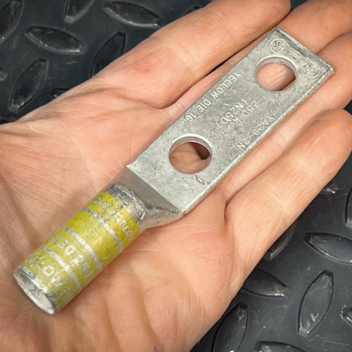 Burndy YA29-2N lug held in hand, pad stamped 250 kcmil N250 YELLOW DIE 16