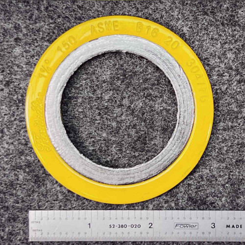 Flexitallic 1-1/4 inch spiral wound gasket top face beside inch ruler, yellow outer ring