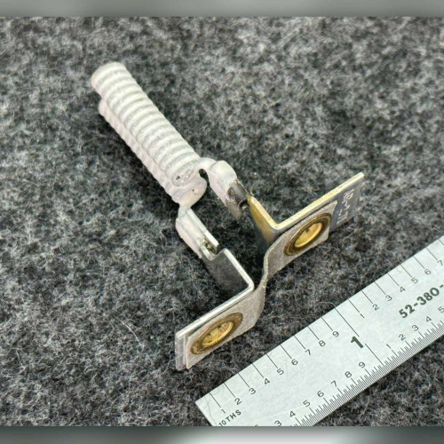 Square D AR-2.71 heater element with white ribbed coil and brass eyelet terminals beside ruler.