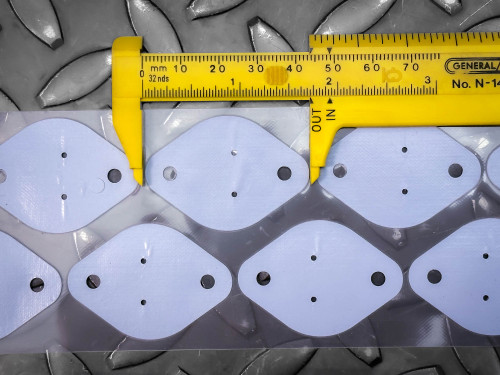 Silicone insulator pads on clear sheet showing clean, unused condition. Yellow caliper General No. N-14 measuring width.