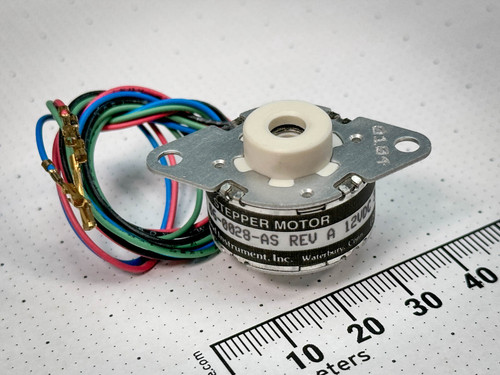 Haydon 06-0028-AS can-stack stepper linear actuator, angled view with millimeter ruler and coiled leads