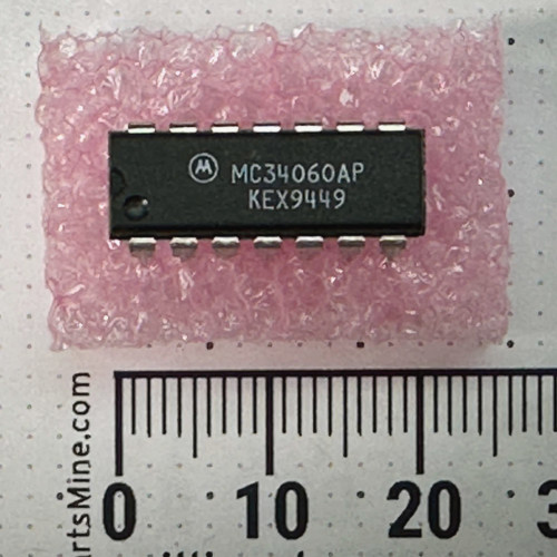 Motorola MC34060AP 14-pin DIP marked KEX9449 on pink antistatic foam beside millimeter ruler