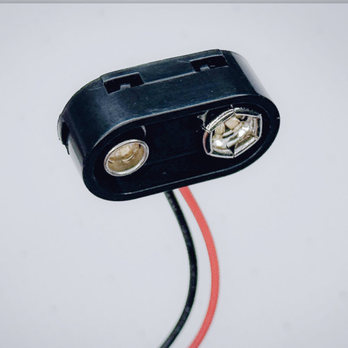 9V battery snap connector showing metal terminal contacts and wire leads.