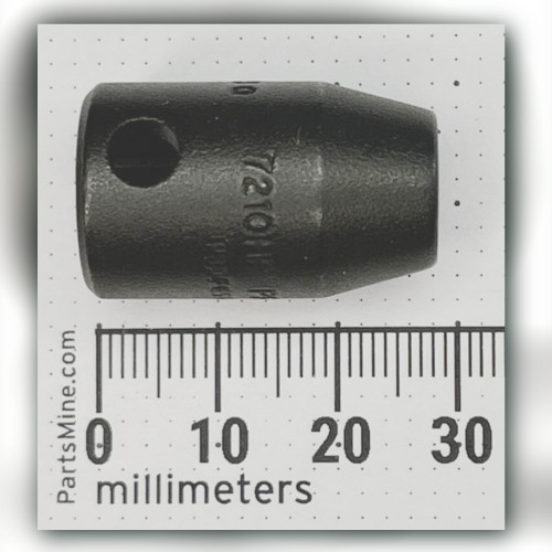 Dark Proto impact socket beside millimeter ruler, 7210HF struck into the body